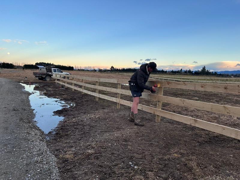 Rails going onto a new post and rail fence in the evening light