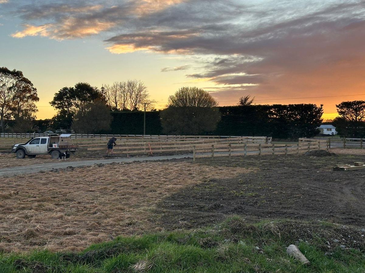 A long run of new post and rail fencing across a North Canterbury paddock